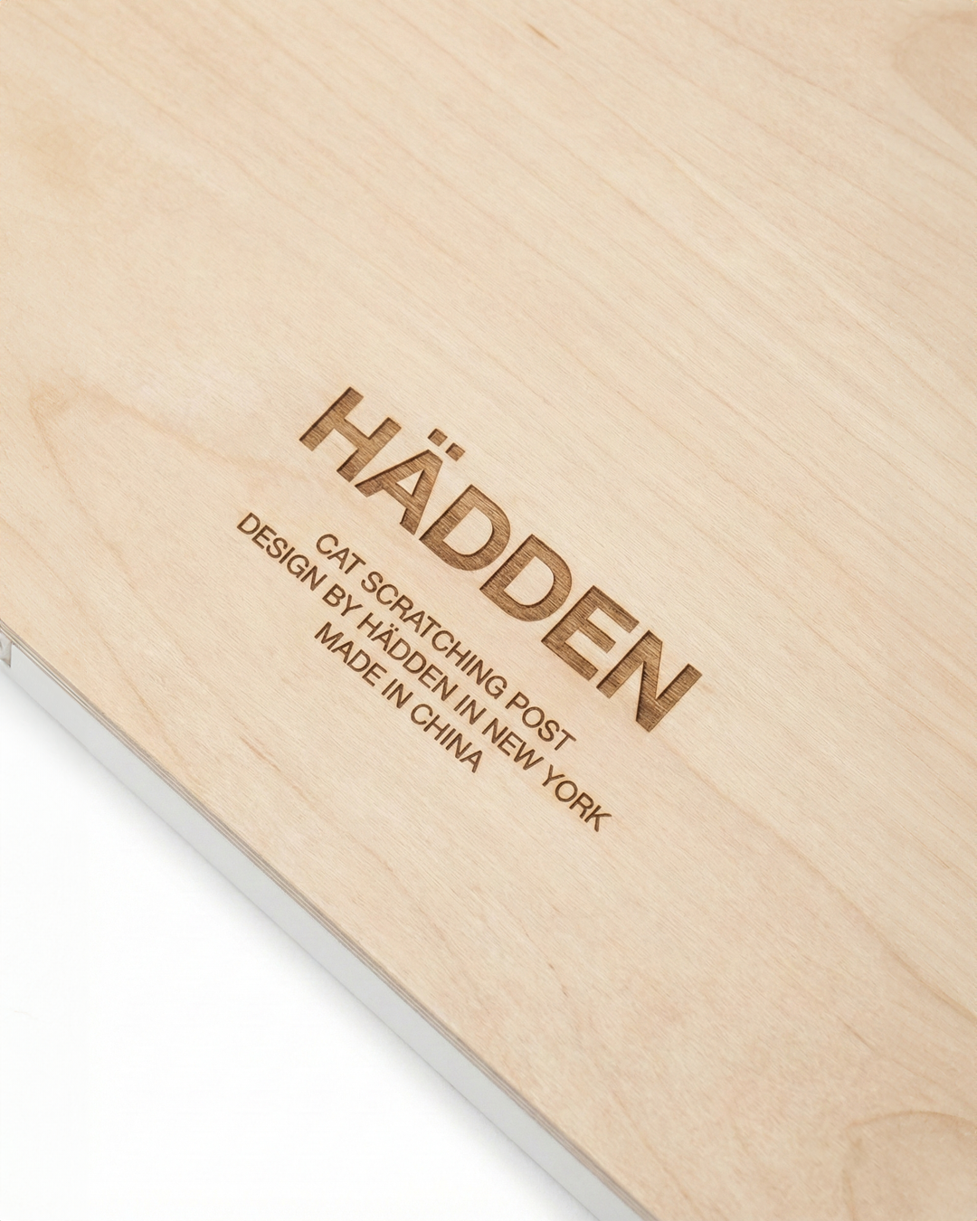 Wooden cat scratching post with 'Hadden' branding and text.