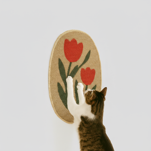 Cat playing with a jute toy with red tulips on a light gray background