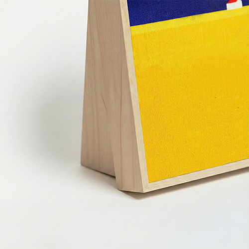 Side profile of HÄDDEN vertical scratching board showing the stable wood base. Ergonomic angle perfect for cats to stretch