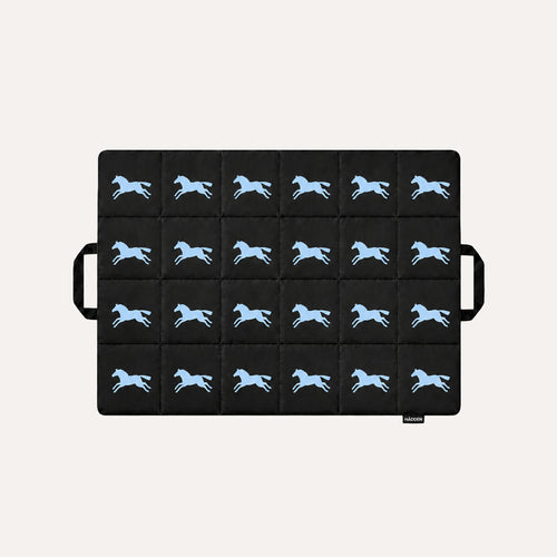HÄDDEN Nomad Mat in black, a quilted cat travel mat with a light blue galloping horse print and two carry handles