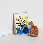 Orange cat next to HÄDDEN floral standing scratcher. Artistic pet furniture that adds a bright pop of color to modern home decor